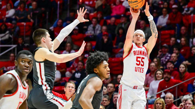 Dec 29, 2023; Salt Lake City, Utah, USA; Utah Utes guard Gabe Madsen (55) takes a three point shot over Washington State Cougars forward Andrej Jakimovski (23) during the second half at the Jon M. Huntsman Center. Mandatory Credit: Christopher Creveling-USA TODAY Sports